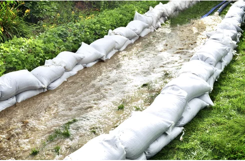 sand bags next to running water